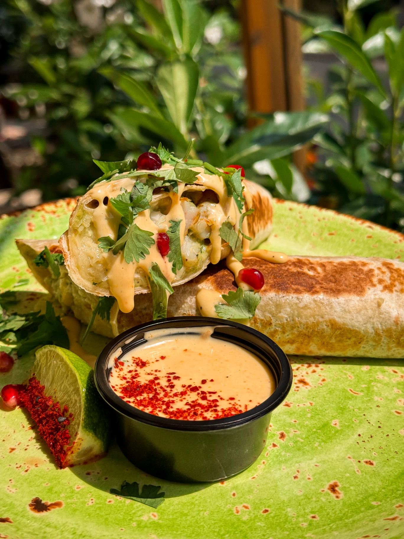 Enchilada Smakosza, czyli enchilada zapiekana z serem, z krewetkami w chimichurri, kalafiorem w majonezie kolendrowym, guacamole z pomidorkami koktajlowymi i cebulką oraz jalapeño, podawana z majo aji, kolendrą i granatem — Panczo